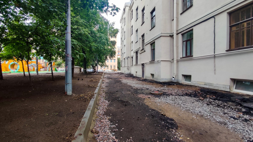 Ремонт тротуара во дворе с разобранным покрытием и детской площадкой